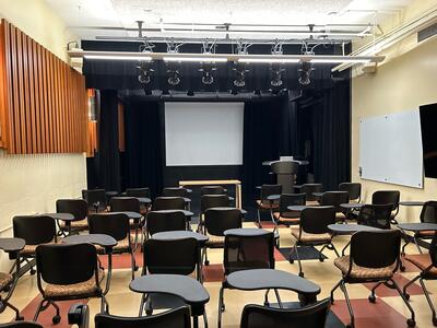 Classroom/presentation space with lectern, rows of chairs